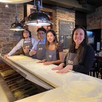 Étudiants d'été 2024 du bureau de Montréal cuisinant de la pizza chez Bevo lors d'un événement organisé par le cabinet.