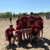 Group of volunteers on sand ground